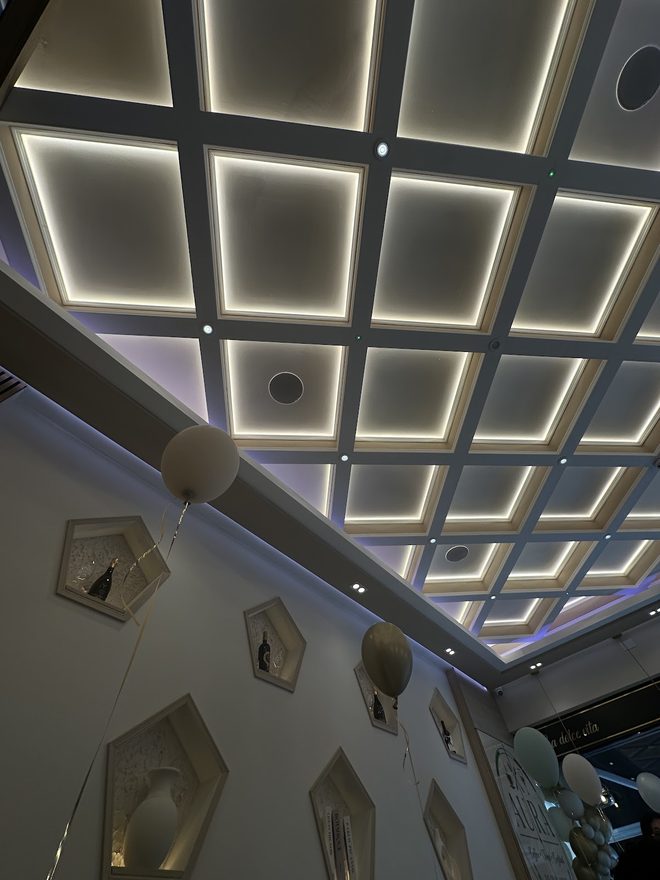 The lit coffered ceiling at Aura